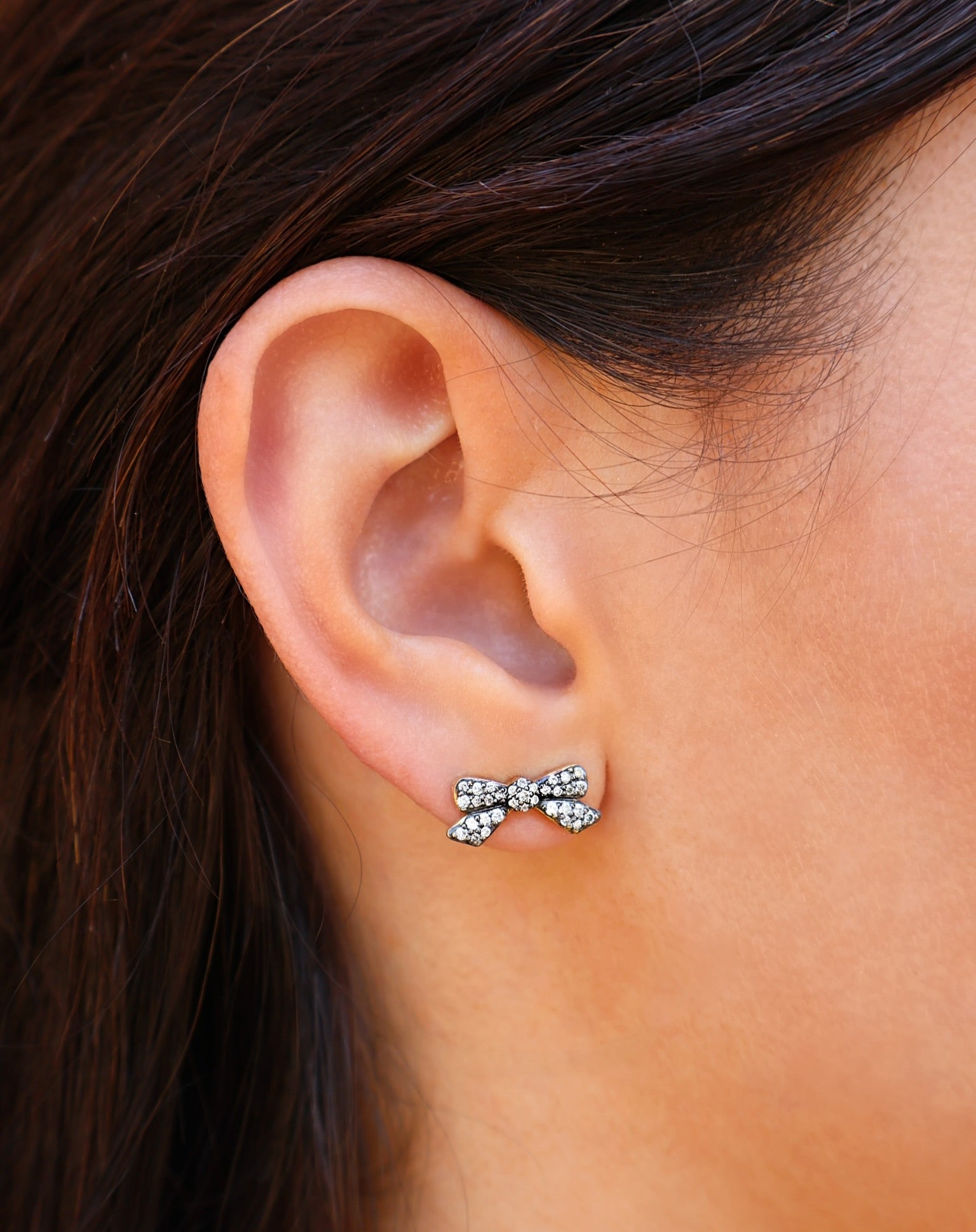 18k yellow gold black rhodium diamond encrusted small bow stud earrings by Jenna Blake Tiny Gods