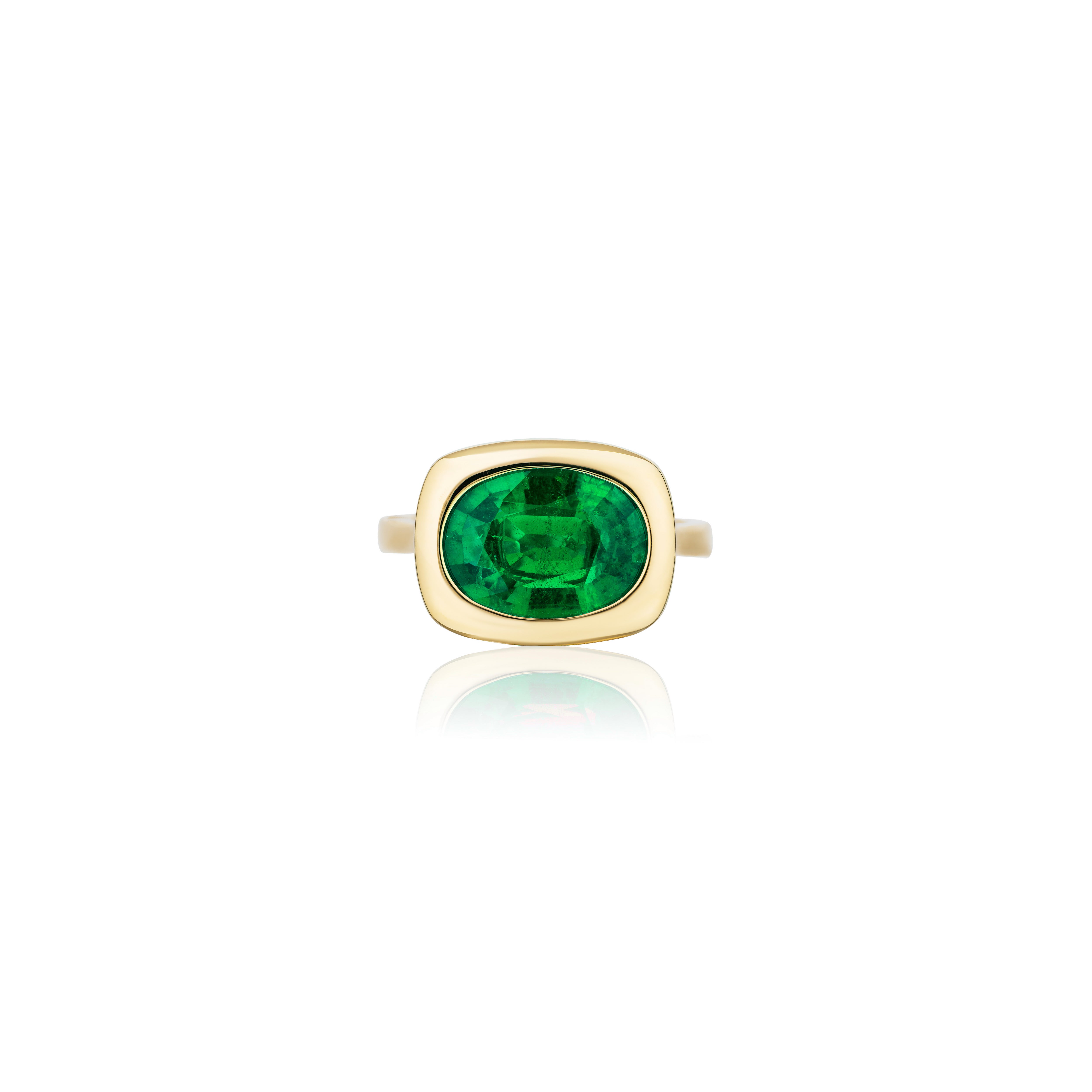 18k yellow gold oval cut emerald set in a rectangular gold bezel setting solitaire ring by Goshwara Tiny Gods