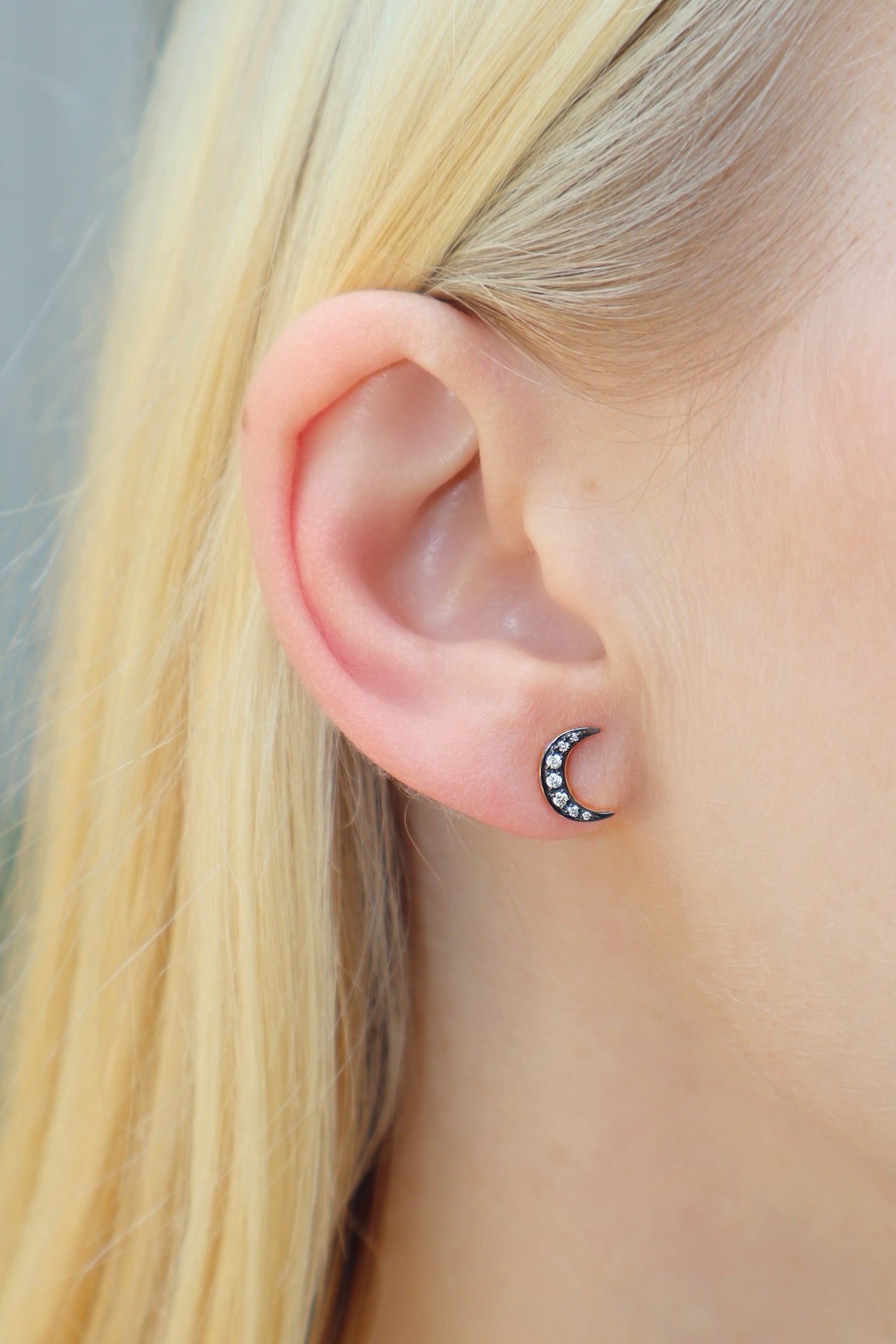 18k yellow gold crescent moon studs with black rhodium detail and diamonds by Sorellina Tiny Gods on model
