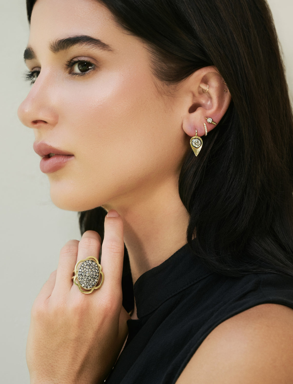 An 18k yellow gold ring with an oval pavé diamond center and a scalloped gold setting Flora Ten Tables Ring by Sylva & Cie on model
