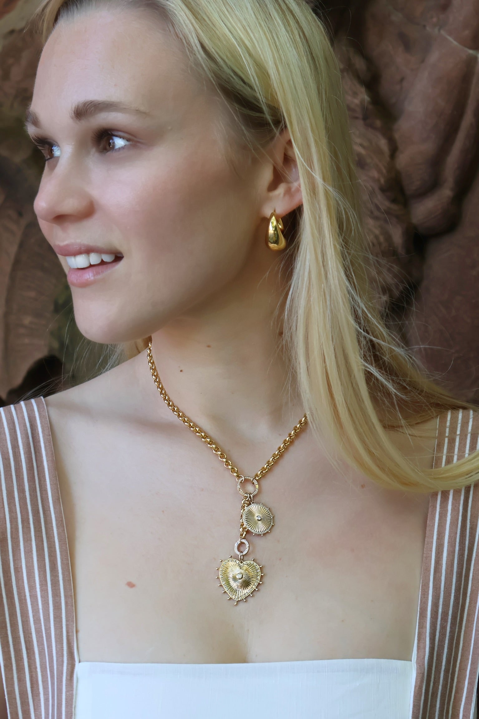 14k yellow gold cassandane small diamond sun medallion by Lionheart Tiny Gods round ribbed foundrae ray charm tiny gods on model