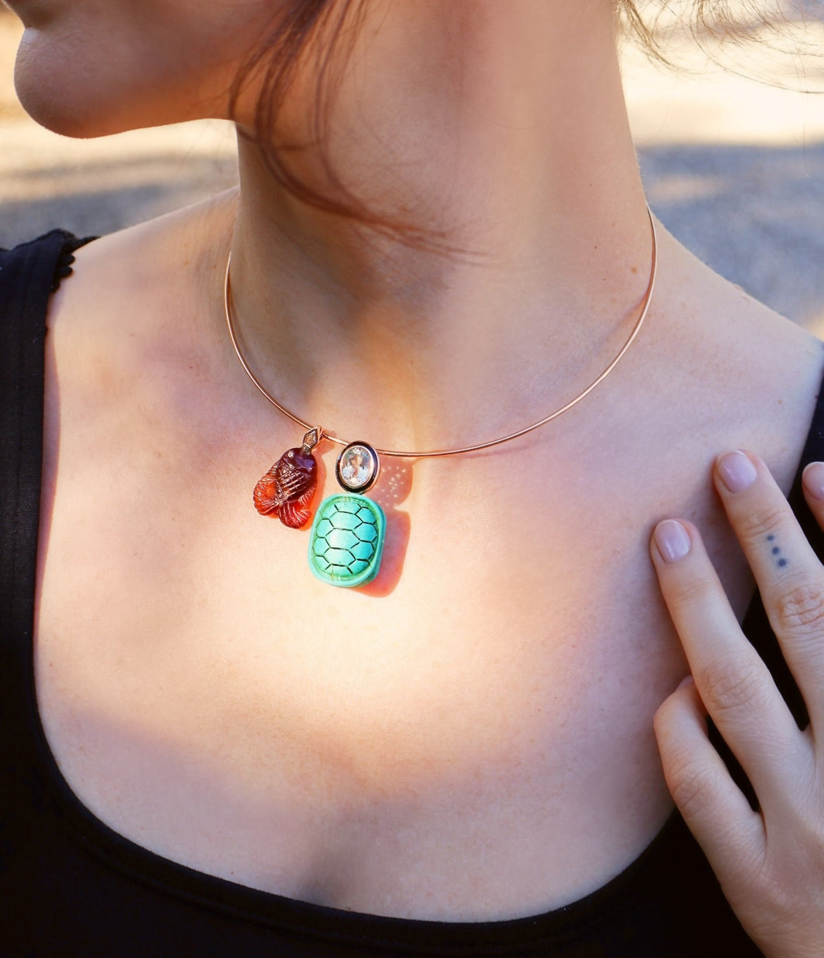 18k rose gold cared garnet fish pendant with diamond accents by Dezso Tiny Gods