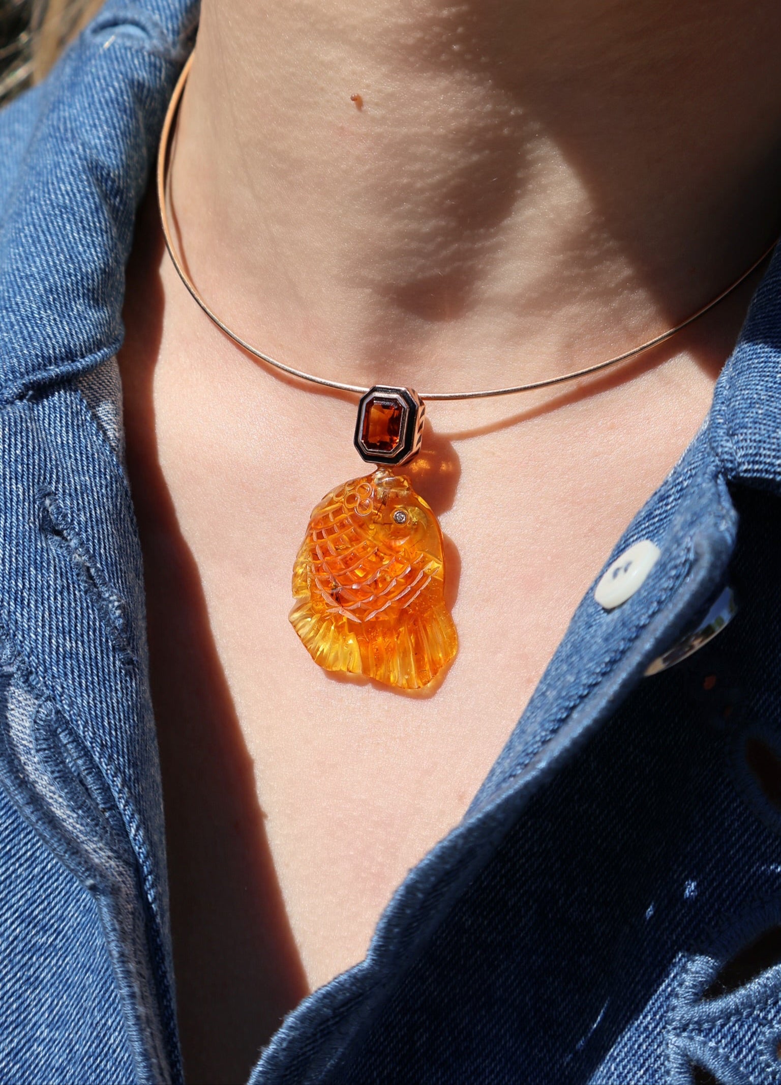 18k rose gold carved amber fish pendant with emerald cut citrine in a black enamel bezel setting charm pendant by Dezso Tiny Gods