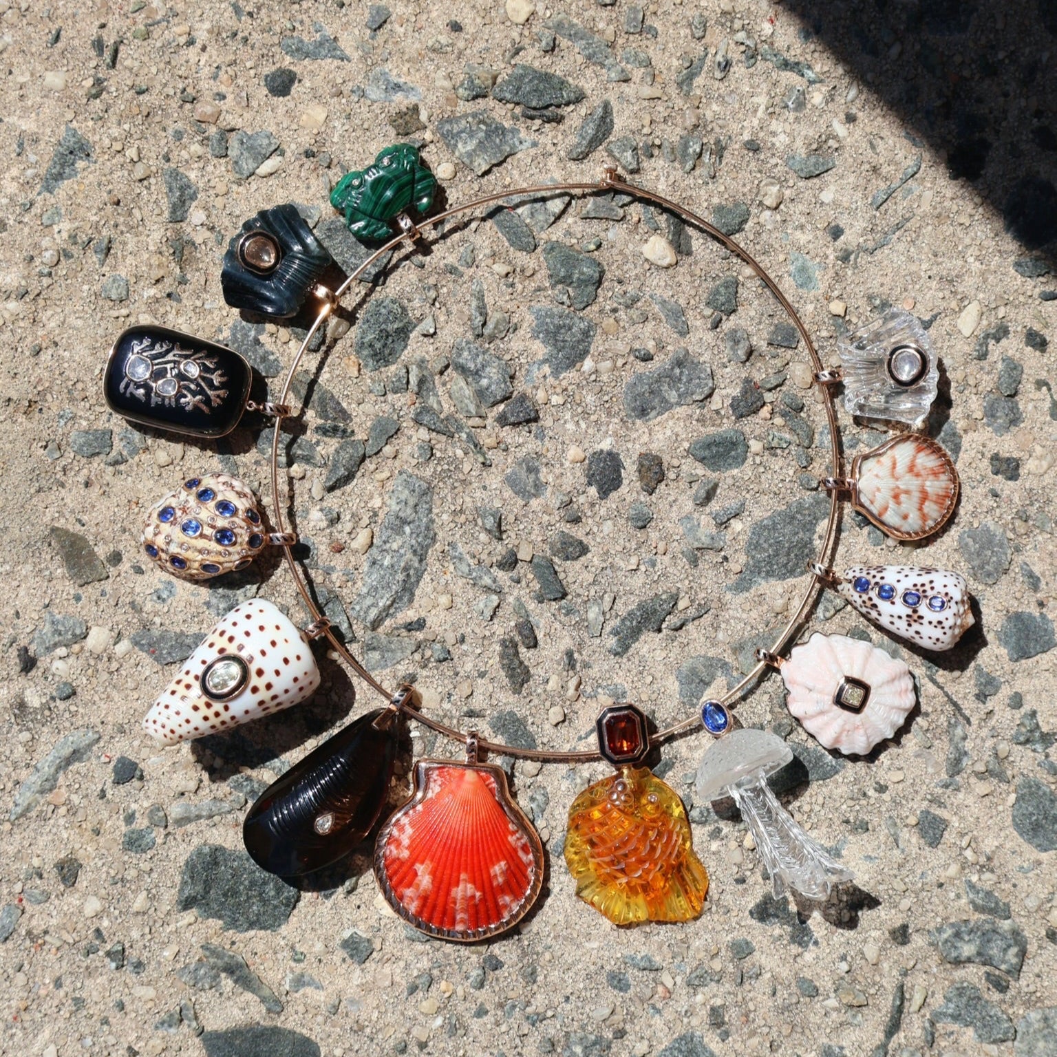 18k rose gold white shell speckled with brown spots with diamond accent with black enamel bezel charm pendant by Dezso Tiny Gods