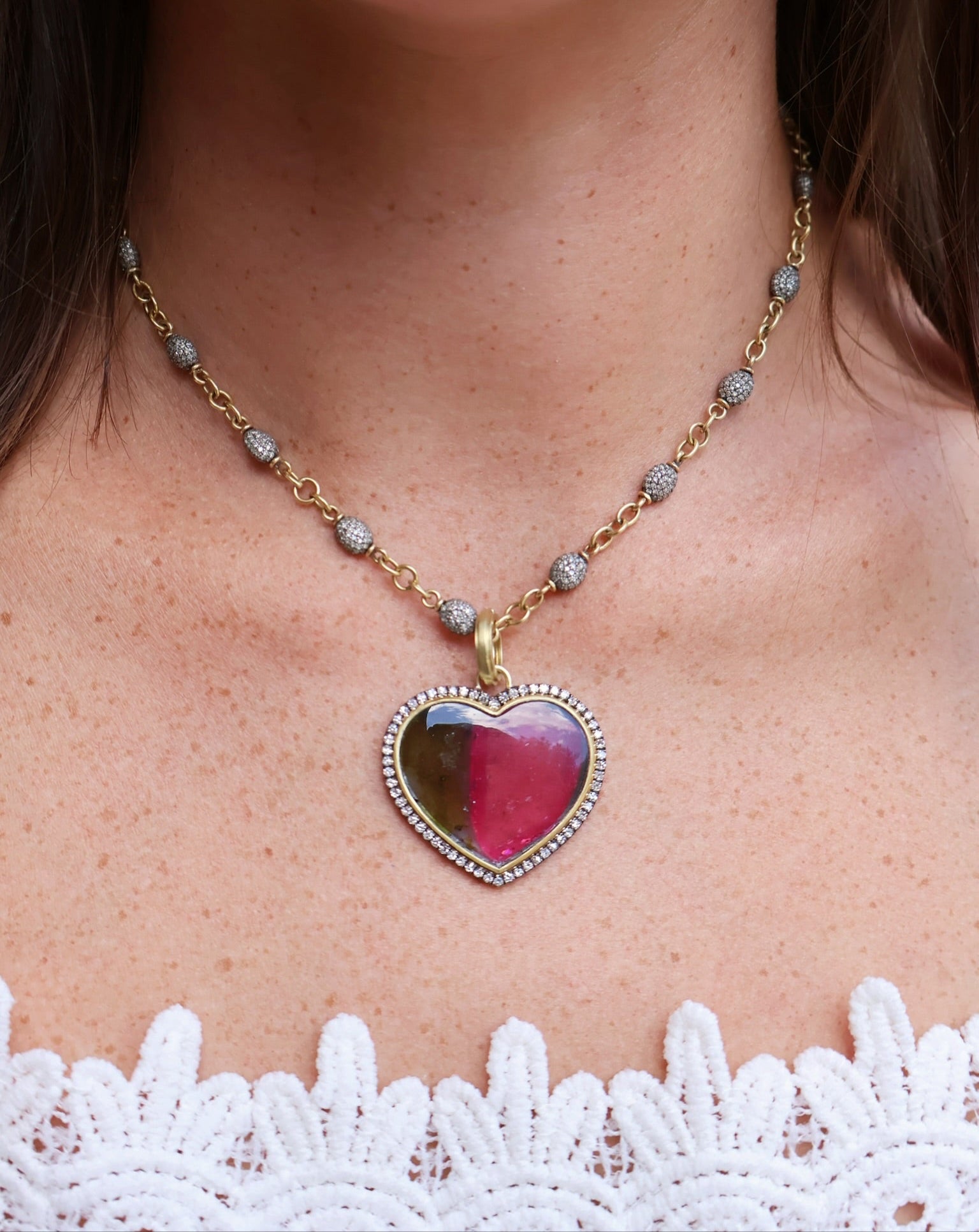 18k yellow gold bi colored water melon tourmaline pink and green heart pendant with diamond border by Sylva Cie Tiny Gods
