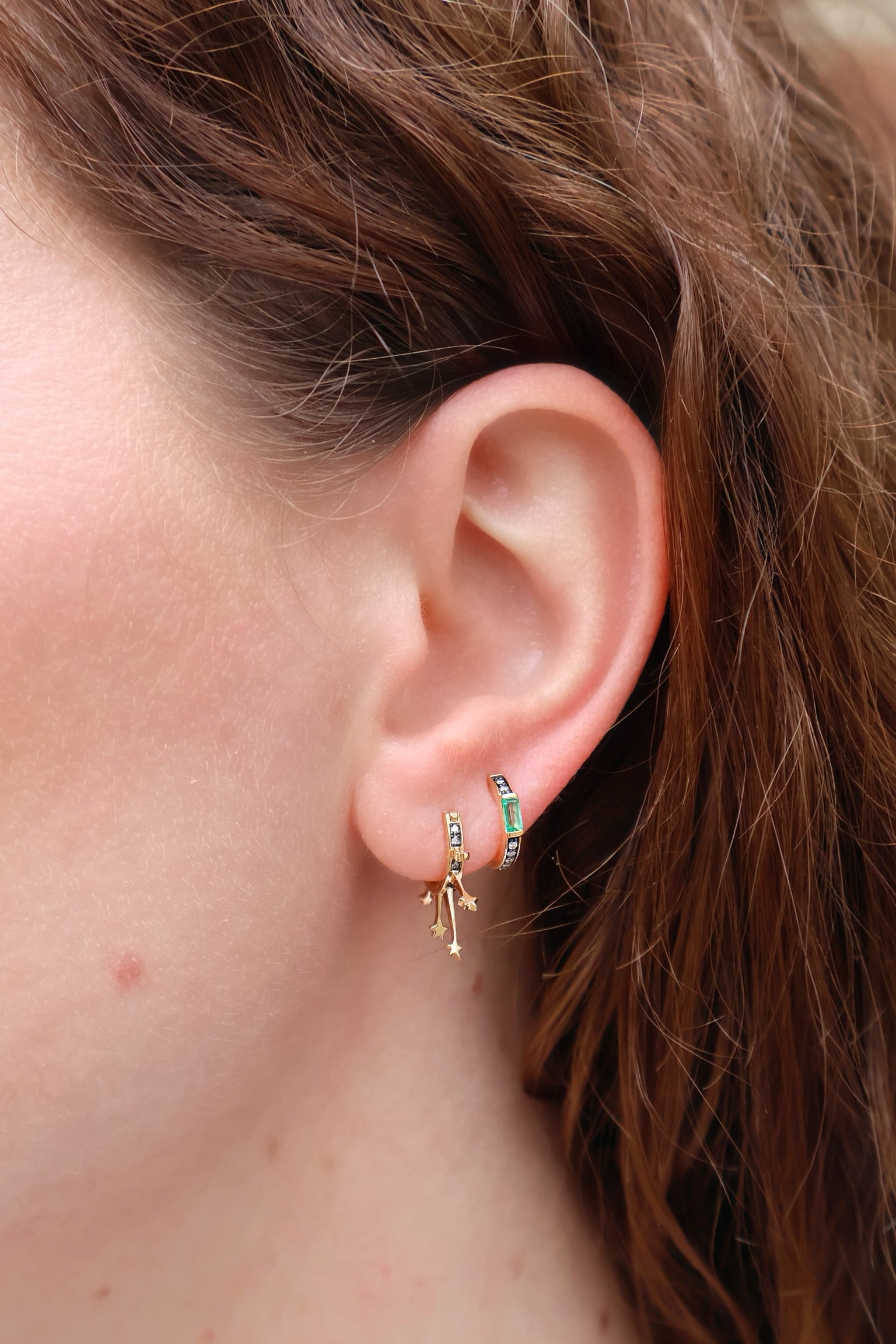 18k yellow gold otto earrings with emerald, diamonds and black rhodium detail by Sorellina Huggies on model Tiny Gods