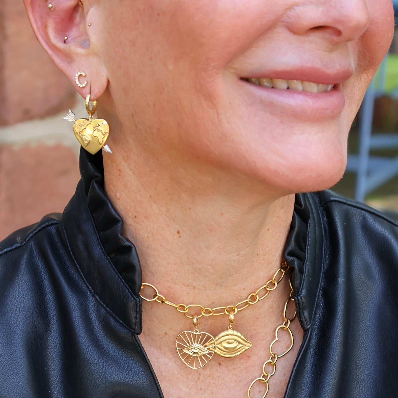 18k yellow gold world globe heart earrings with diamond arrow piercing on hoops by Christina Alexiou Tiny Gods