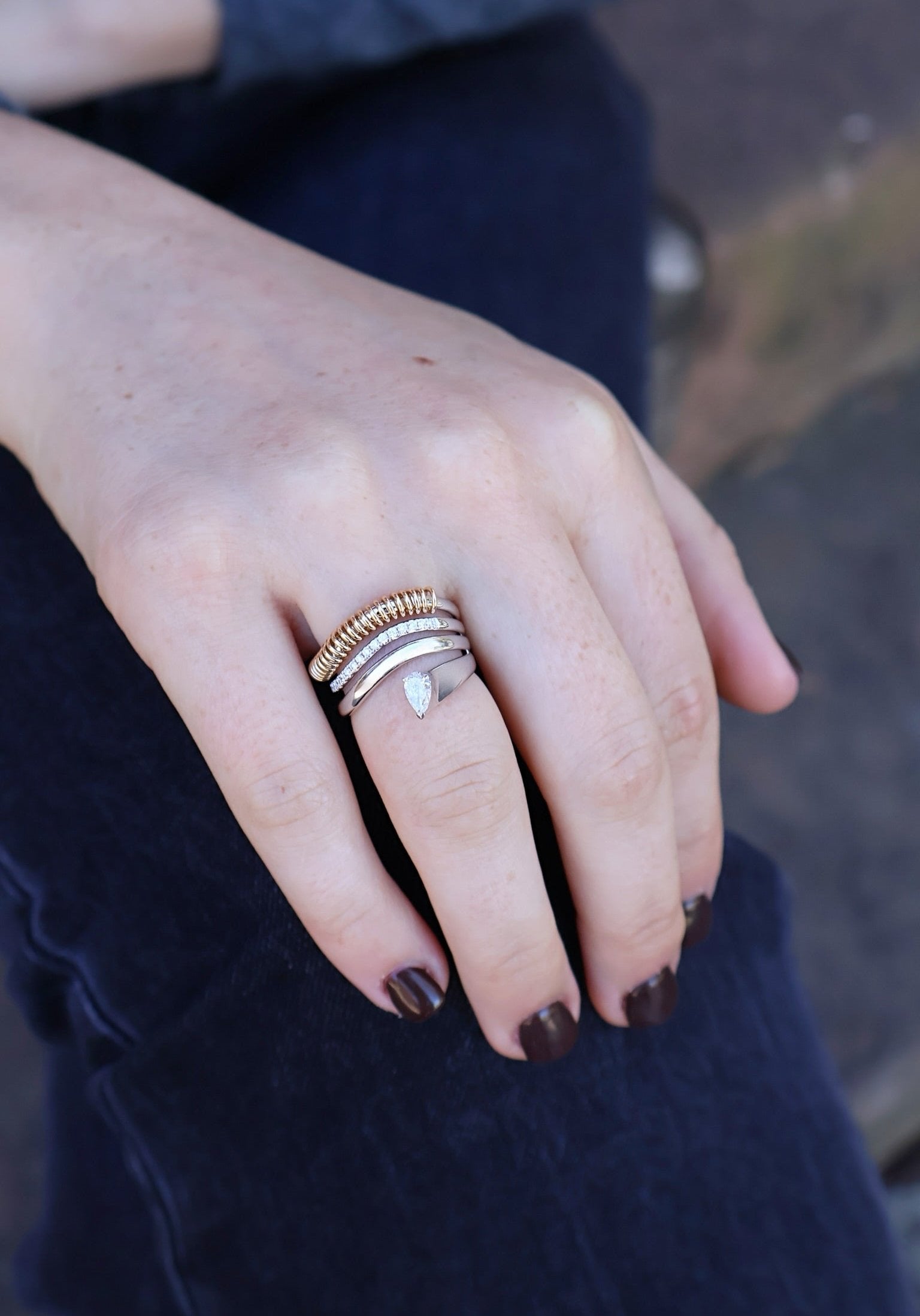 rainbow k coil wrap yellow gold and pave pear shaped diamond ring band on model