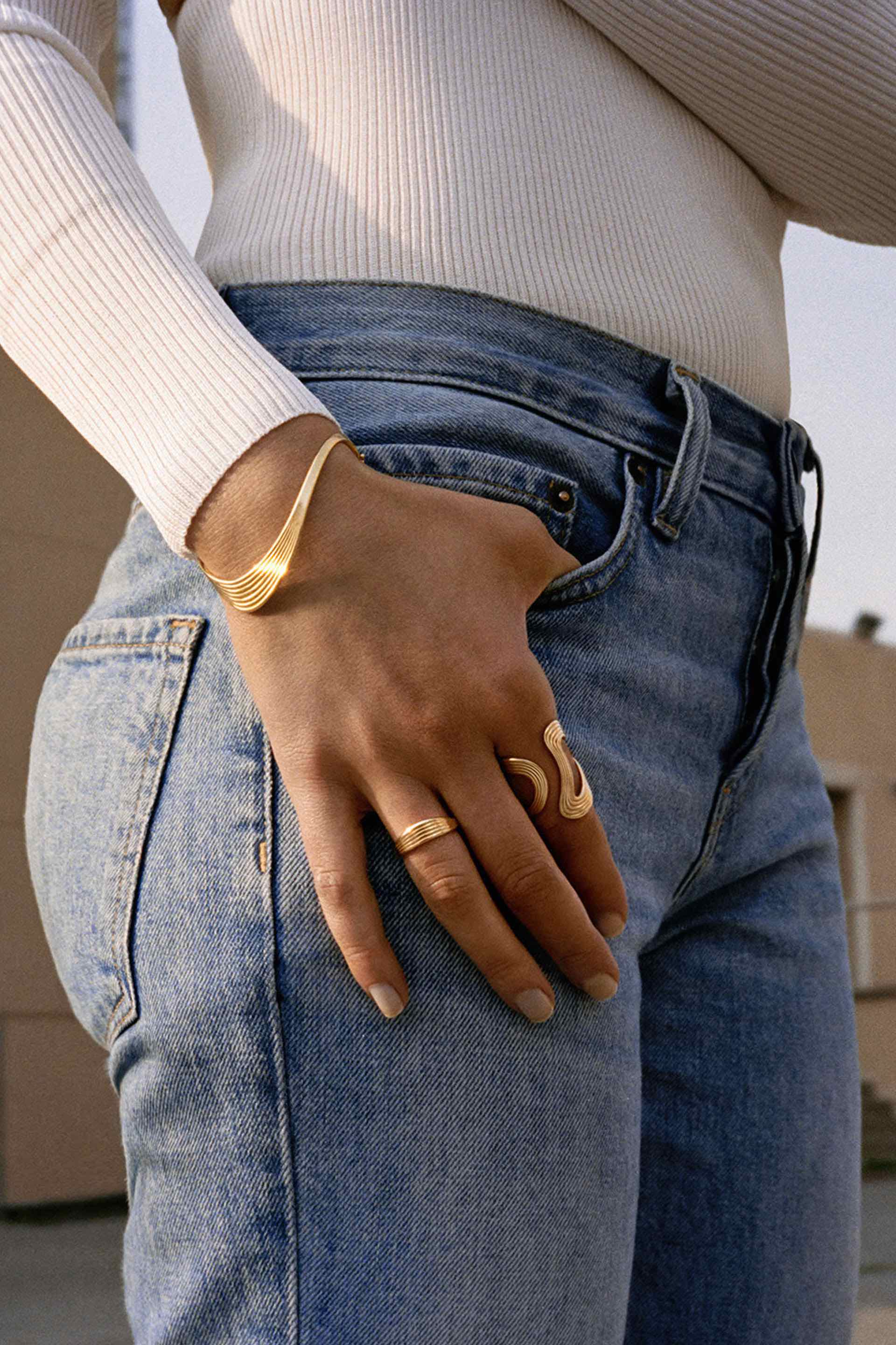 18K yellow gold Stream Lines Open Ring Wave Band by Fernando Jorge Tiny Gods on model