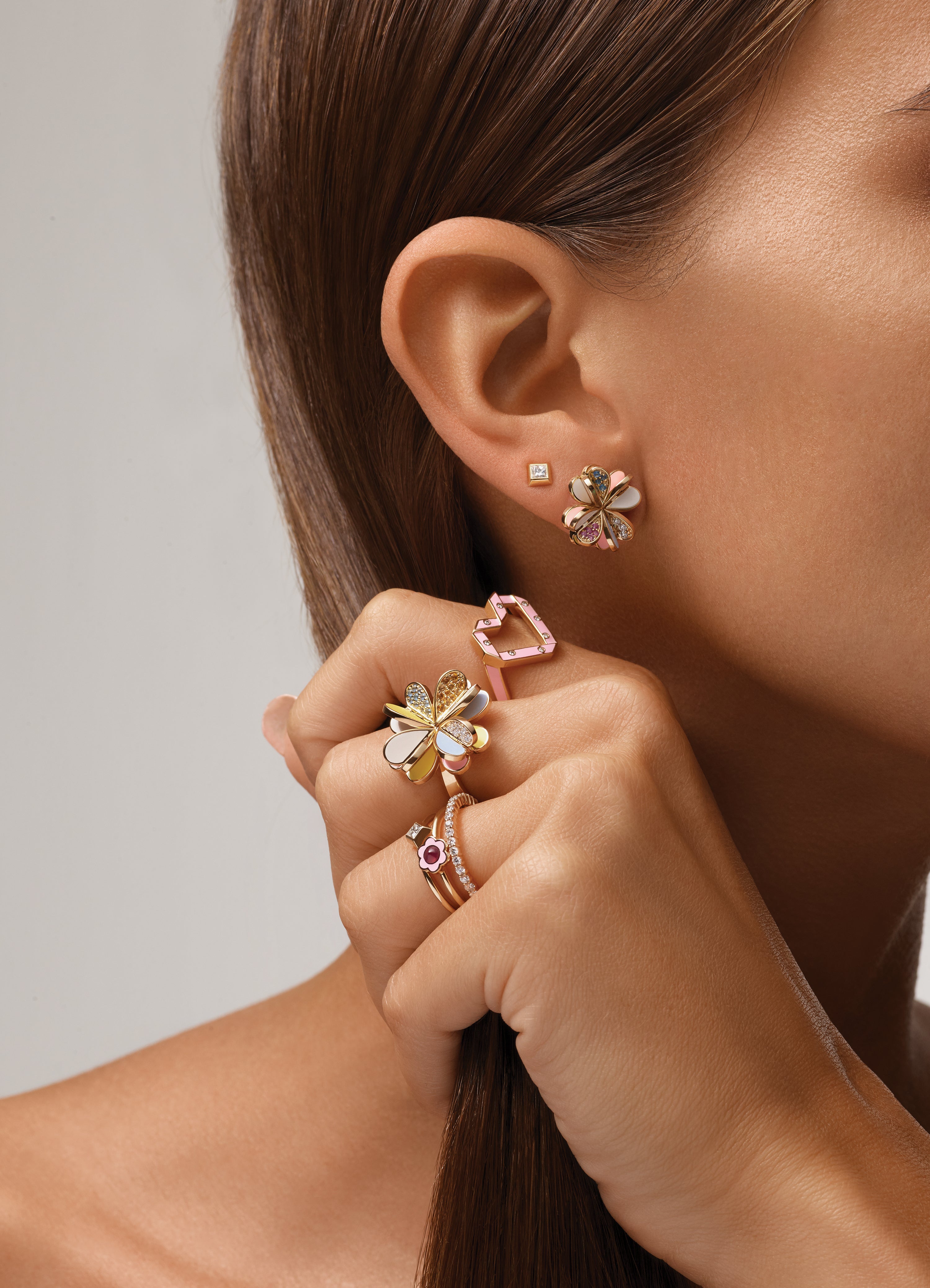 18k yellow gold with white, yellow and blue enamel petals and semi-precious stones Lucky You Earrings by Aisha Baker Tiny Gods four leaf clover stud on model