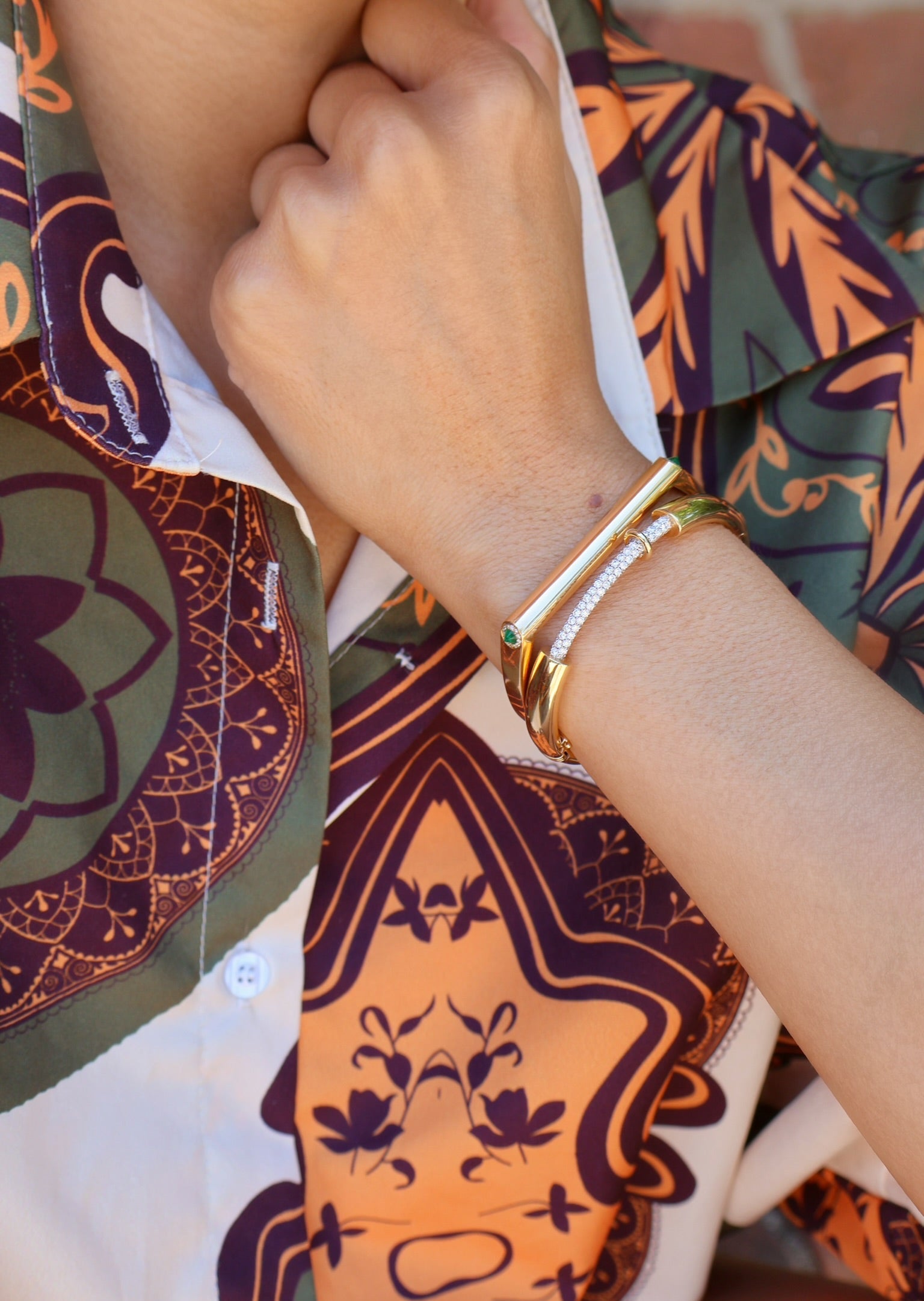 14k yellow gold grace bangle with emerald accents and diamonds by Rainbow K Tiny Gods