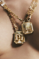 Big Letter "M" initial scapular pendant by Marie Lichtenberg diamonds yellow gold with blue enamel at Tiny Gods on model