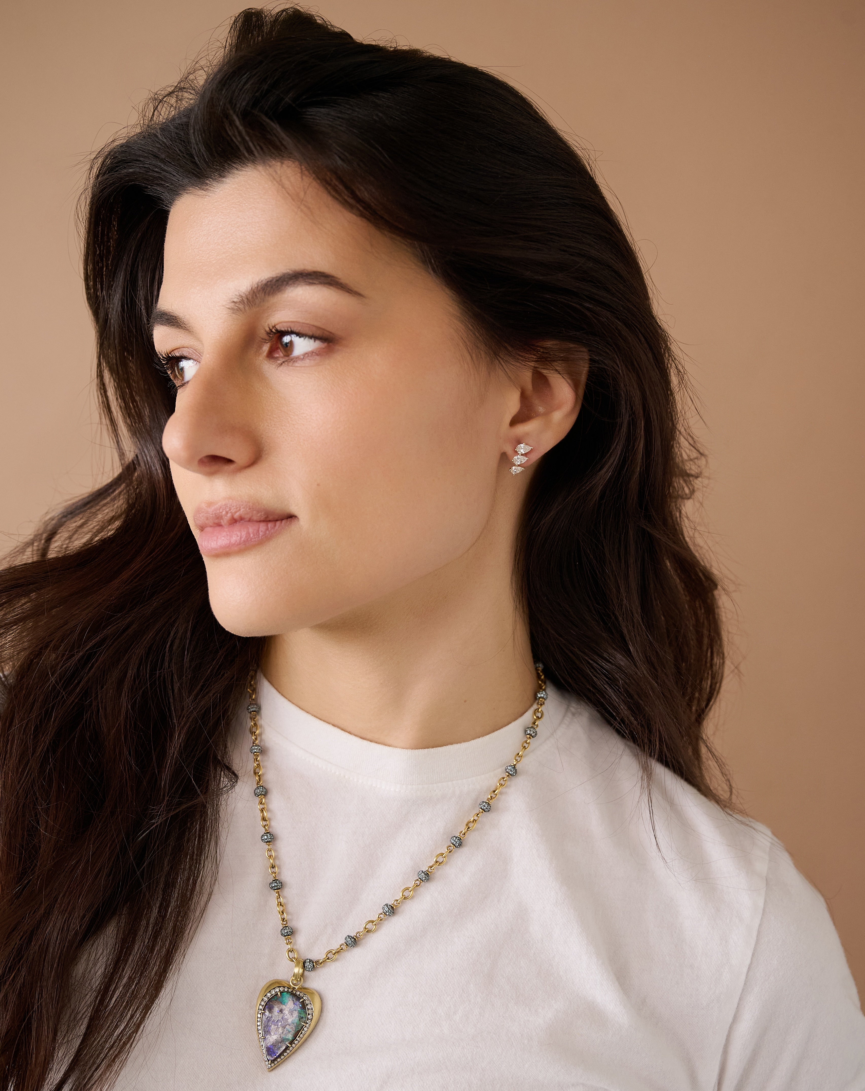 18k yellow gold triple pear diamond curved stud stacked earring by Tiny Gods on model