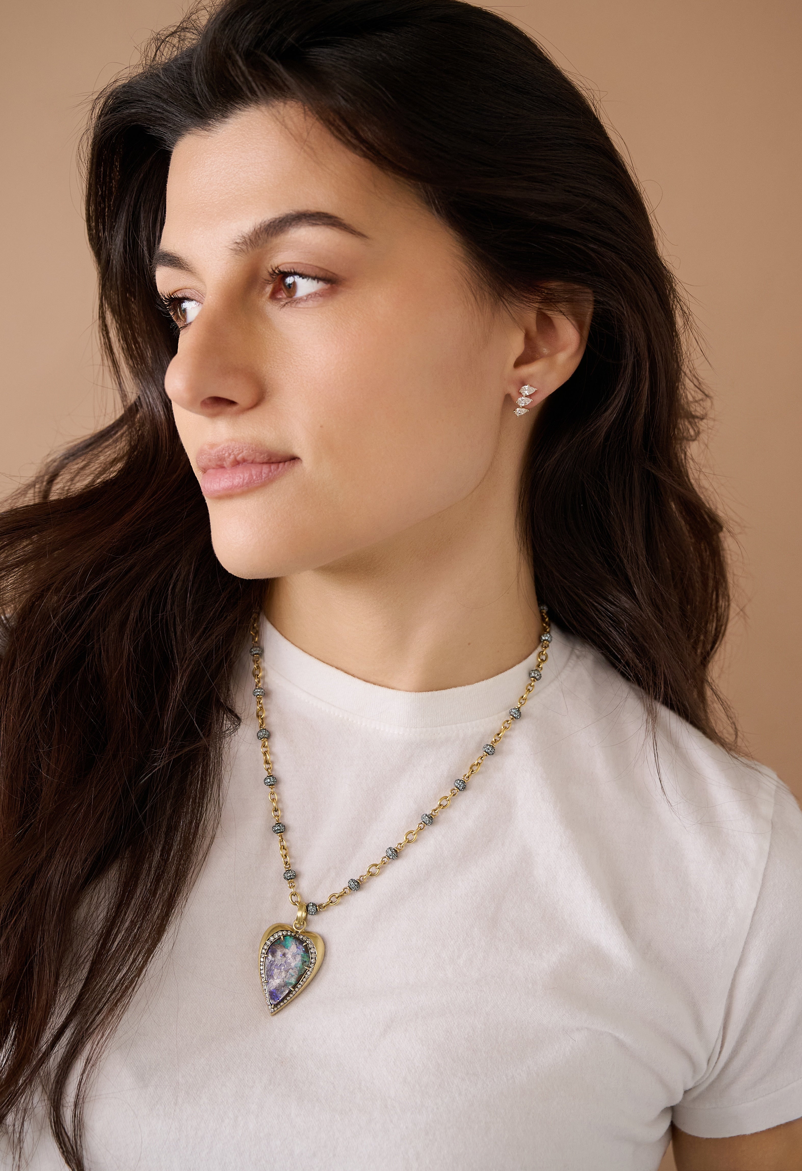 18k yellow gold and silver heart bezel set Australian boulder opal blue green, purple with diamond pendant by Sylva & Cie Tiny Gods on model