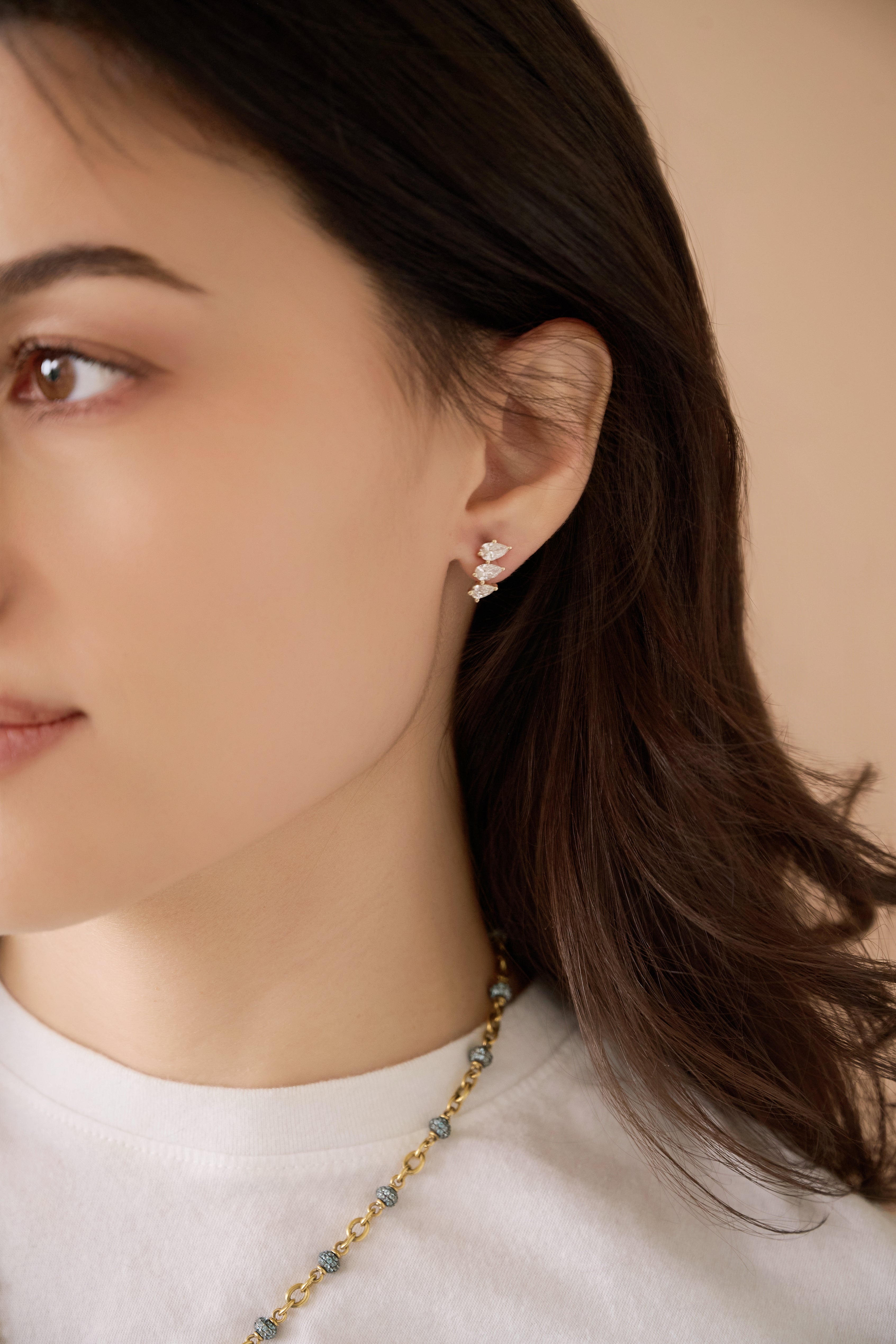 18k yellow gold triple pear diamond curved stud stacked earring by Tiny Gods on model