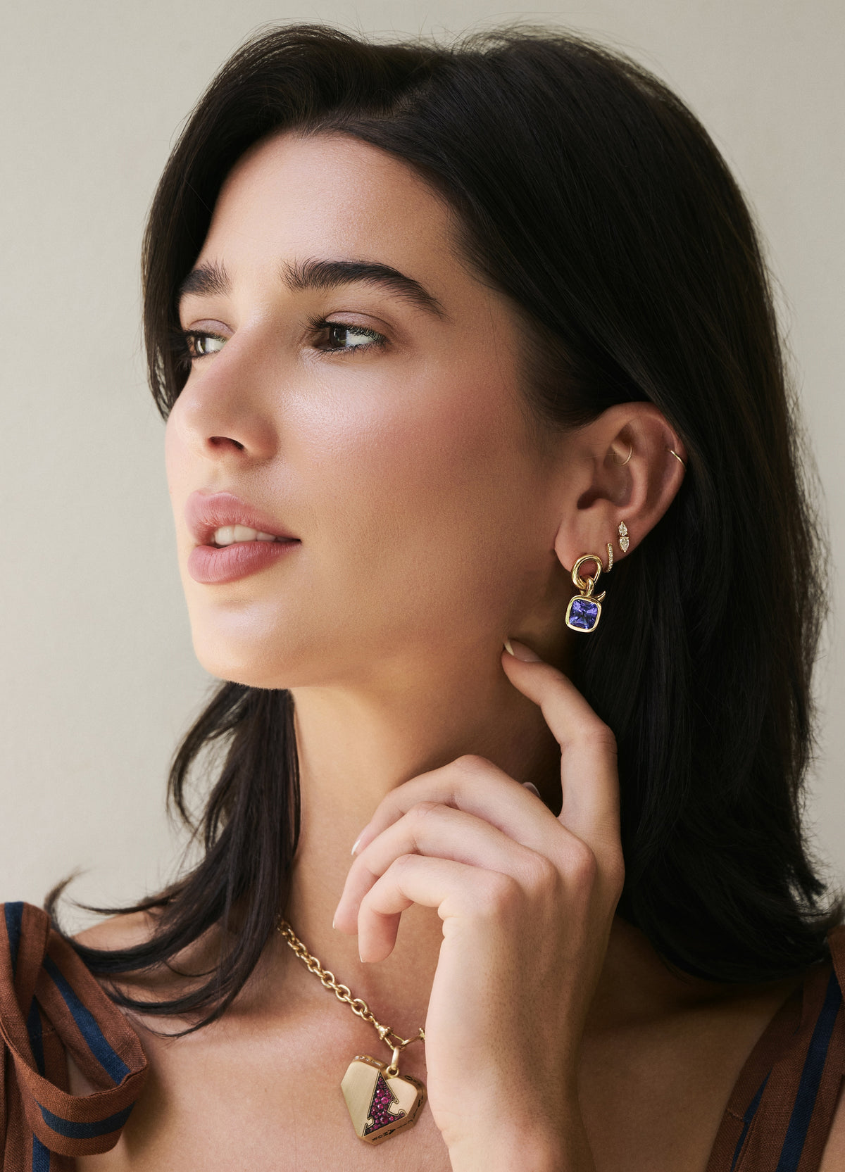 18k yellow gold tied knot tanzanite bezel set earrings vein collection by retrouvai tiny gods on model