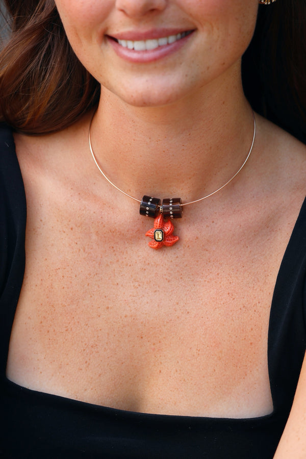 18k rose gold carved coral starfish pendant with black enamel and yellow sapphire by Dezso Tiny Gods
