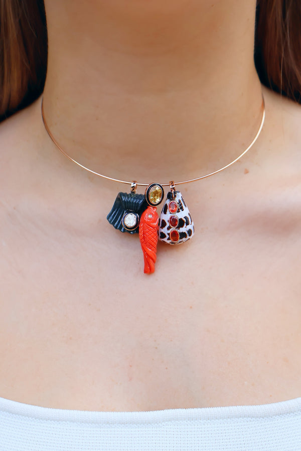 18k rose gold carved mediterranean coral fish with black enamel and yellow sapphire by Dezso Tiny Gods