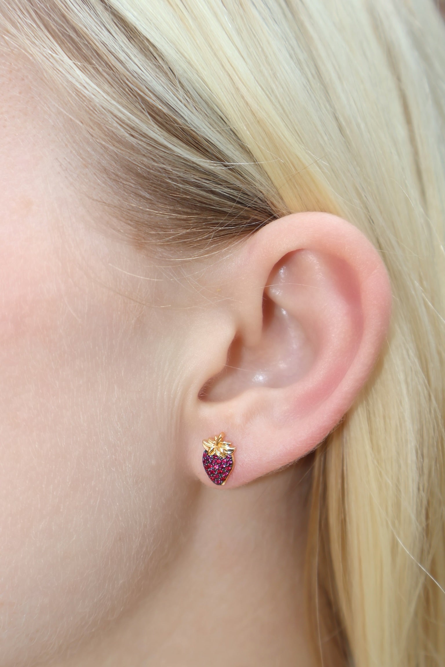 18 k yellow gold strawberry stud earrings with rubies and rhodium detail by Sorellina on model