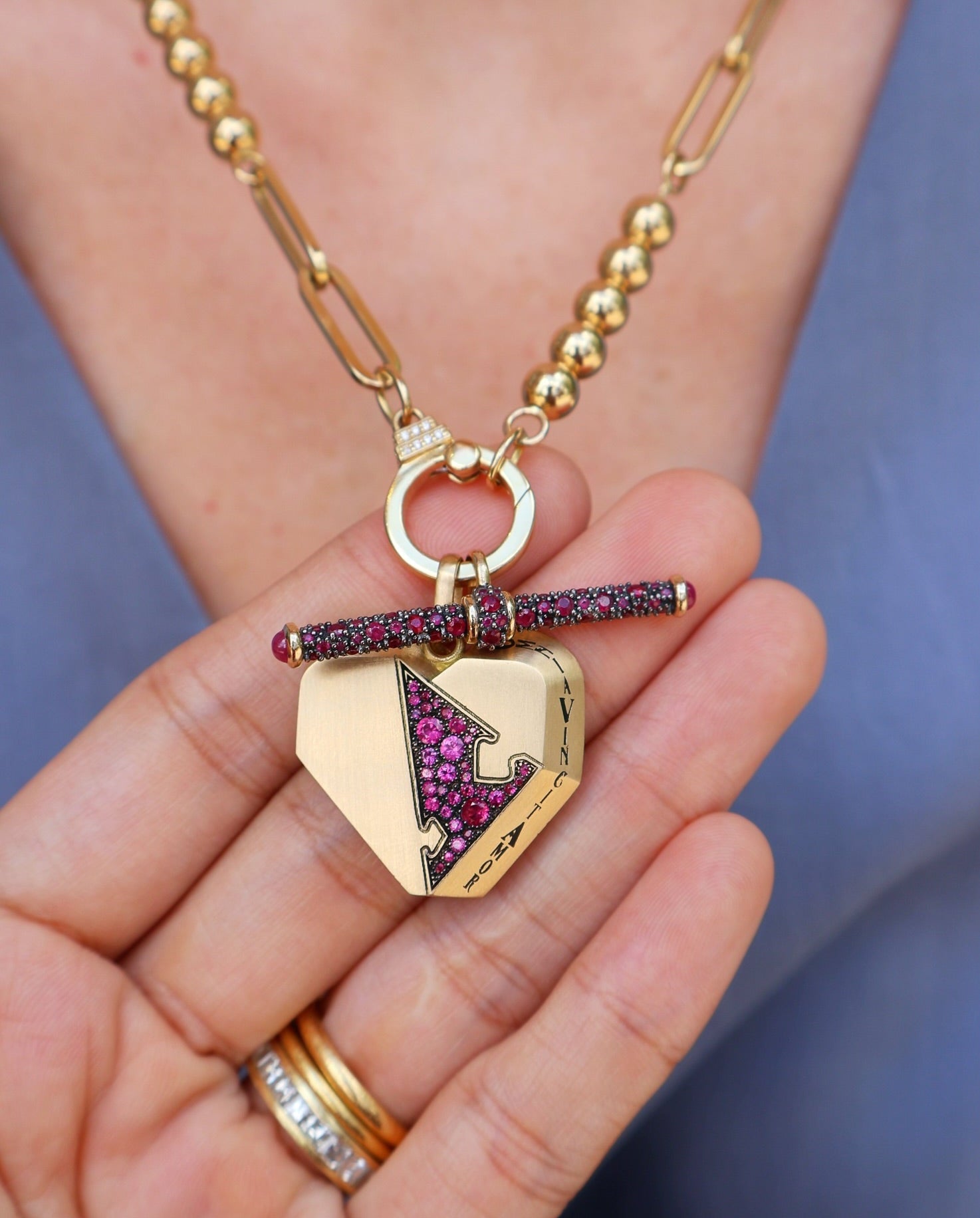 18k yellow gold ruby puzzle piece heart pendant with omnia vincit amor love conquers all, love and victory charm, puzzle talisman collection by Circa 1700 Tiny Gods 
