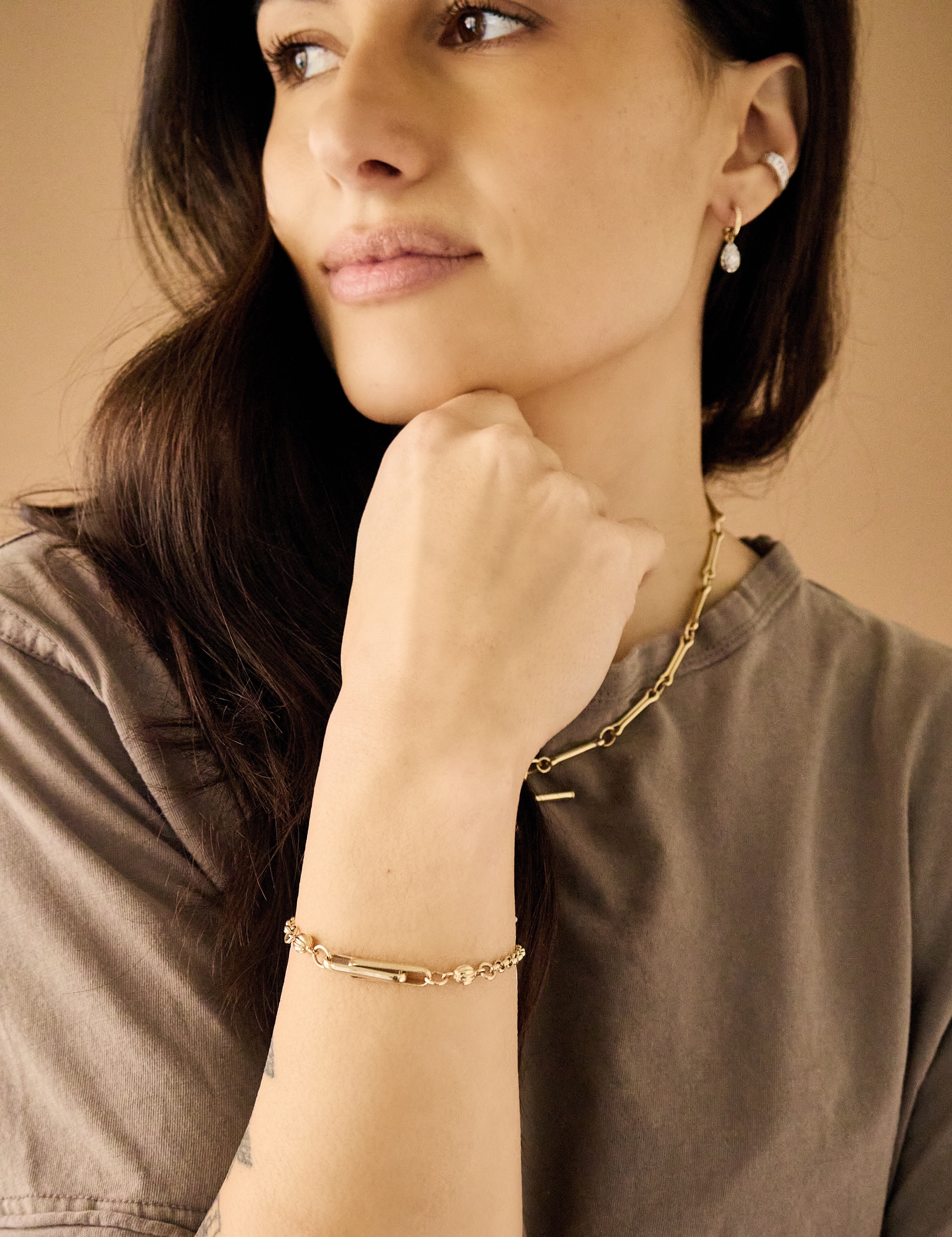Stirrup yellow gold rolo bracelet by Lucy Delius Tiny Gods  on model