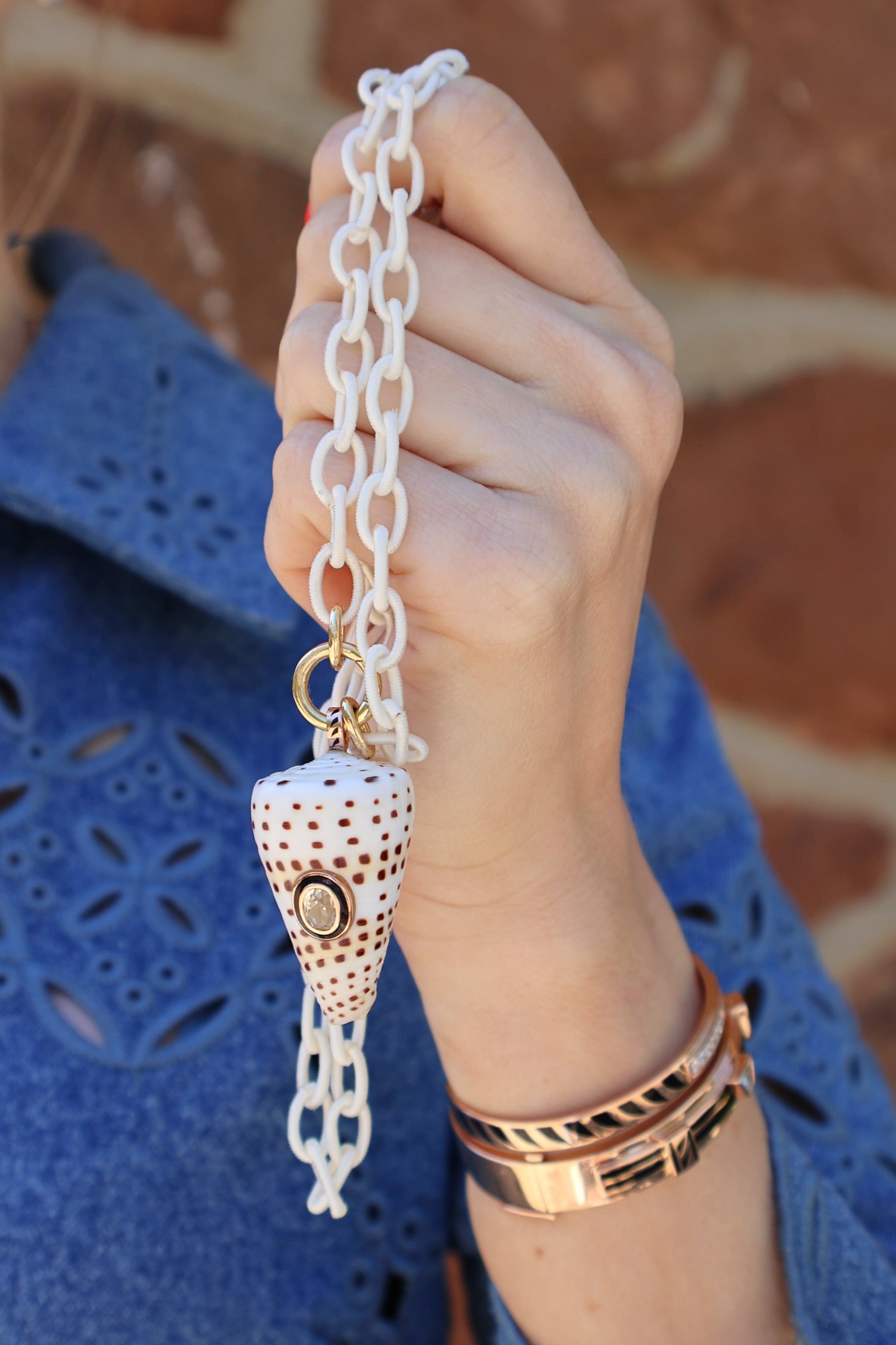 18k rose gold white shell speckled with brown spots with diamond accent with black enamel bezel charm pendant by Dezso Tiny Gods 