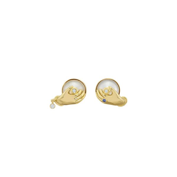 18k yellow gold pearl and diamond hands holding boob stud earrings by Sauer Tiny Gods