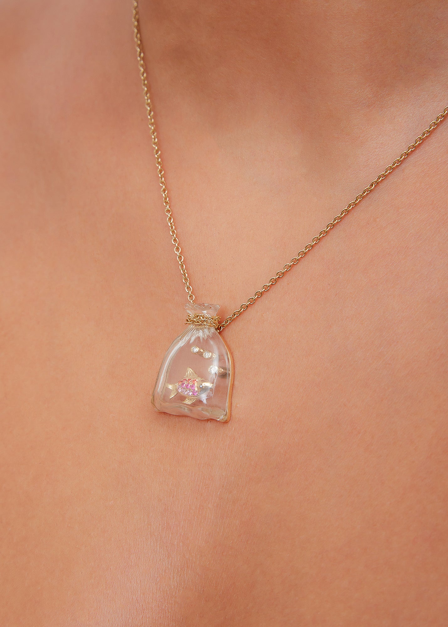 9k yellow gold pink sapphire fish in a crystal carved bag pendant by Yvonne Leon Tiny Gods 