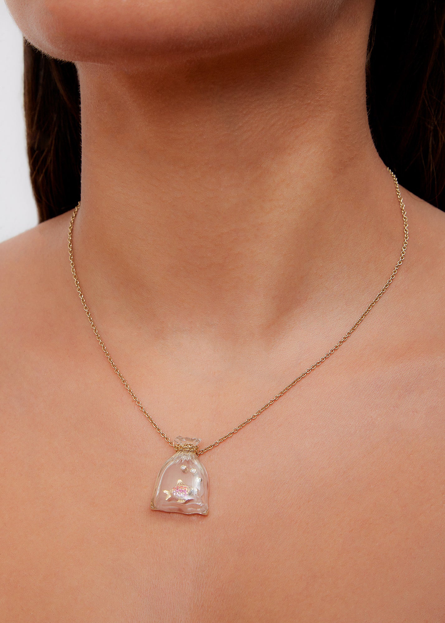 9k yellow gold pink sapphire fish in a crystal carved bag pendant by Yvonne Leon Tiny Gods 