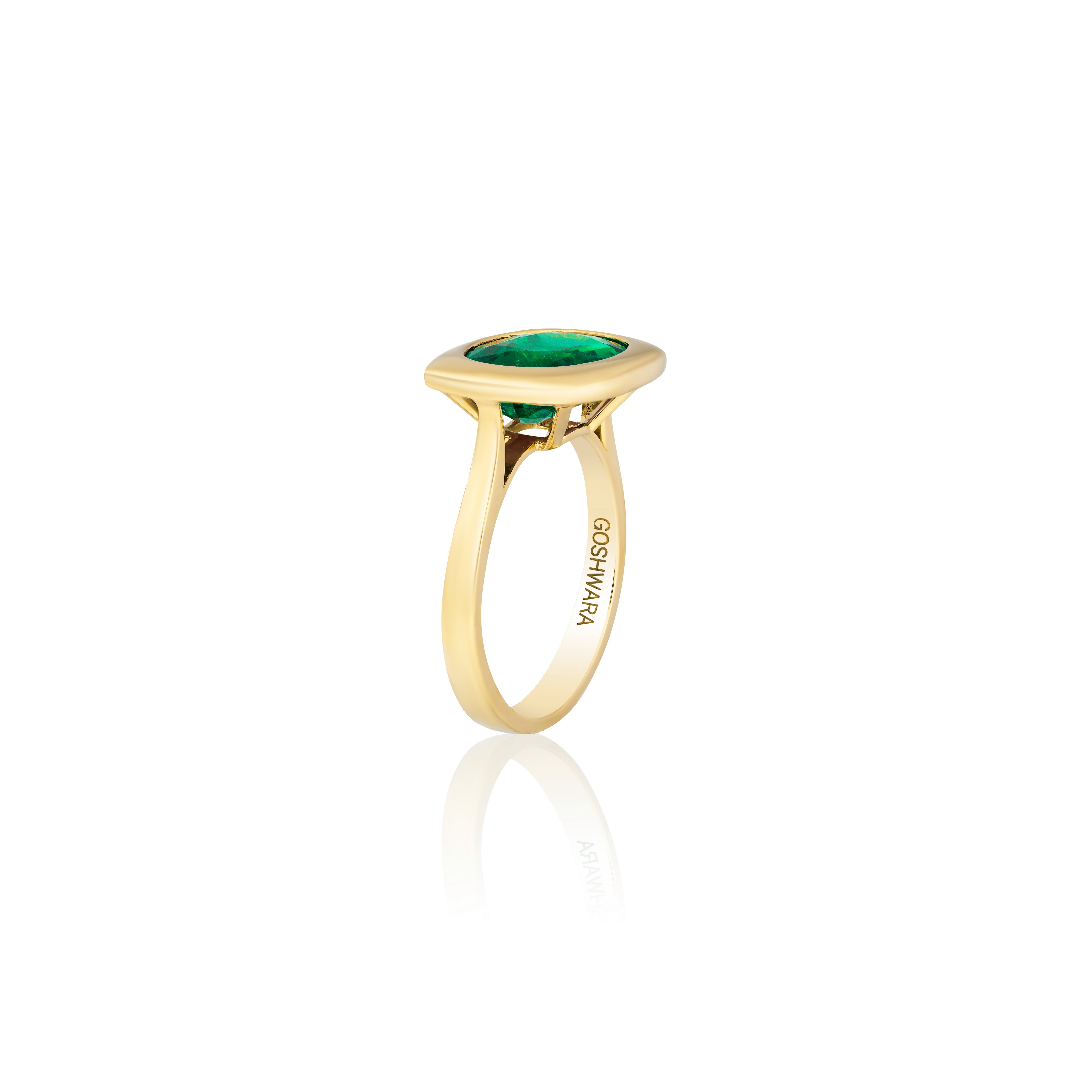 18k yellow gold oval cut emerald set in a rectangular gold bezel setting solitaire ring by Goshwara Tiny Gods 