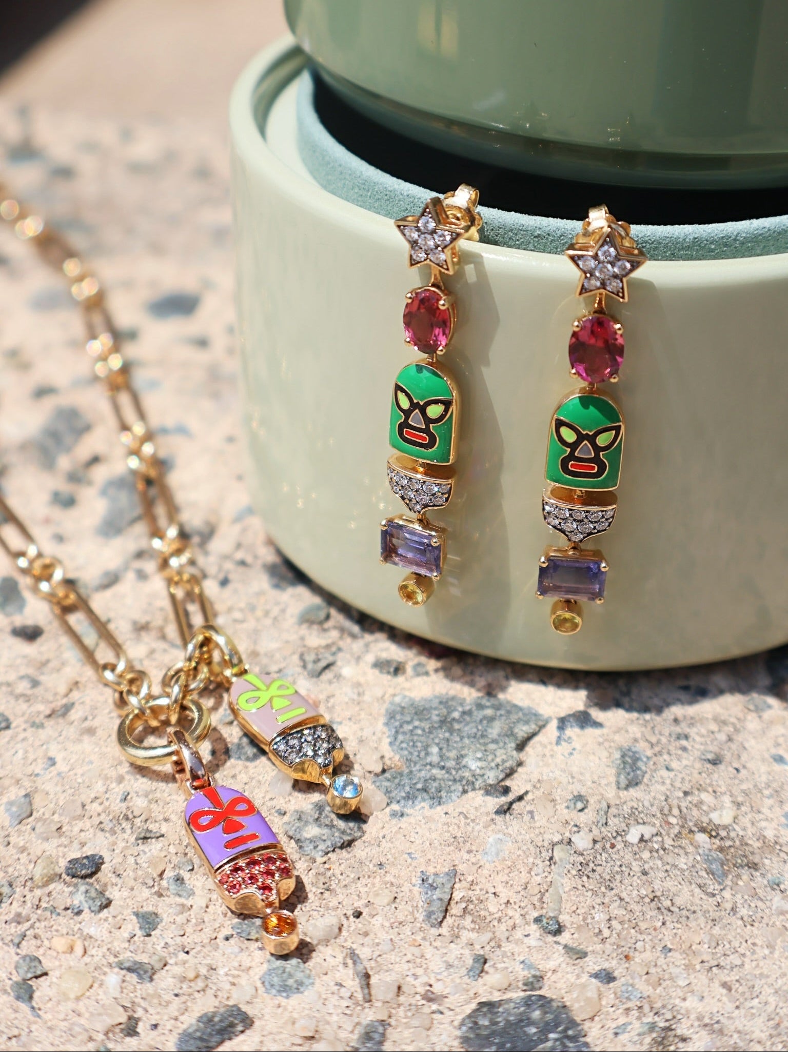 Yellow gold Luchadores hurricane long wrestler dangle star earrings in pink, purple, green by Francesca Villa, Tiny Gods