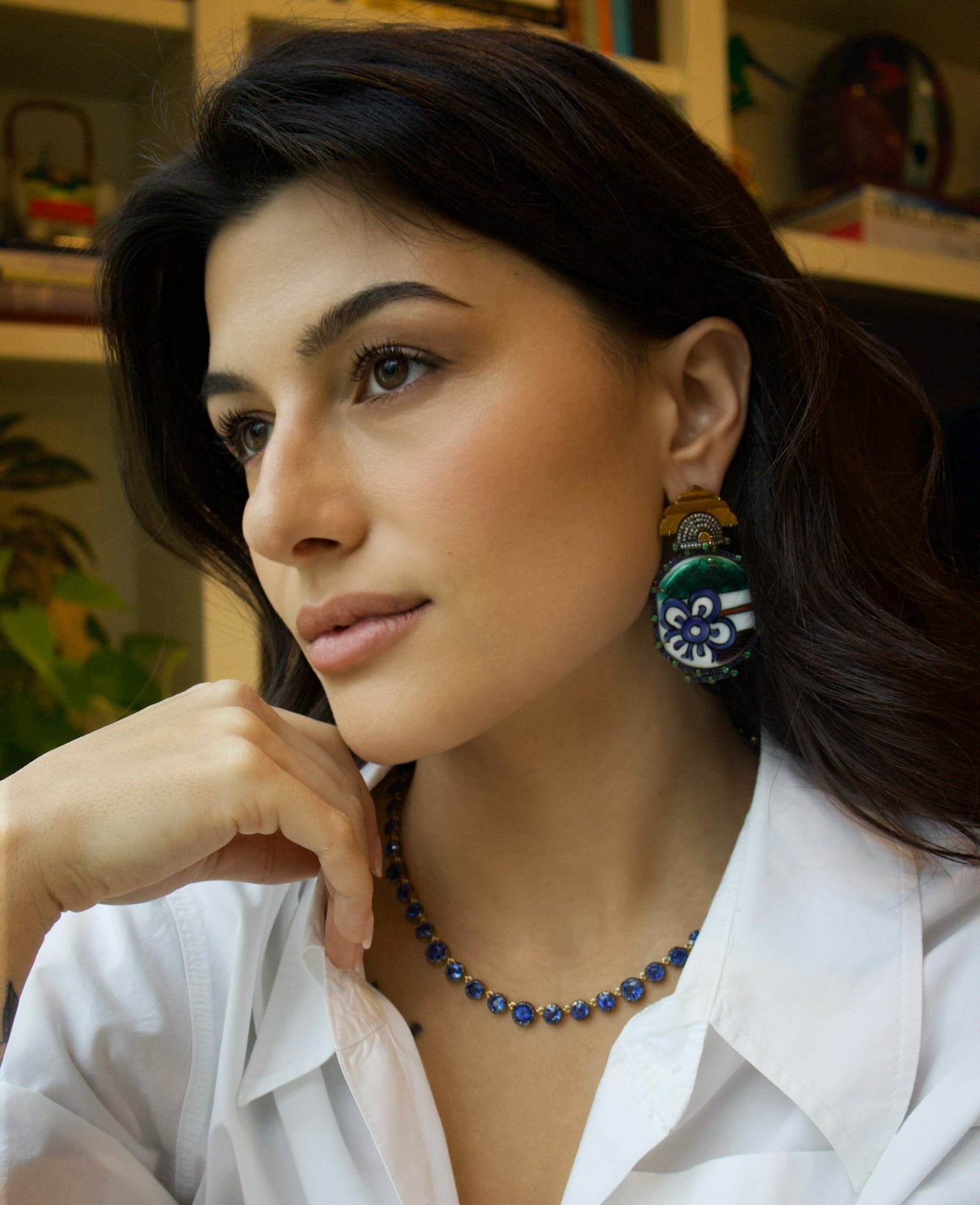 18k yellow gold hand painted blue flower ceramic earrings with blue sapphire and tsavorite border with black and white diamonds and carved tiger's eye earrings by Silvia Furmanovich Tiny Gods 