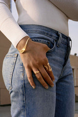 18K yellow gold Stream Lines Open Ring Wave Band by Fernando Jorge Tiny Gods on model