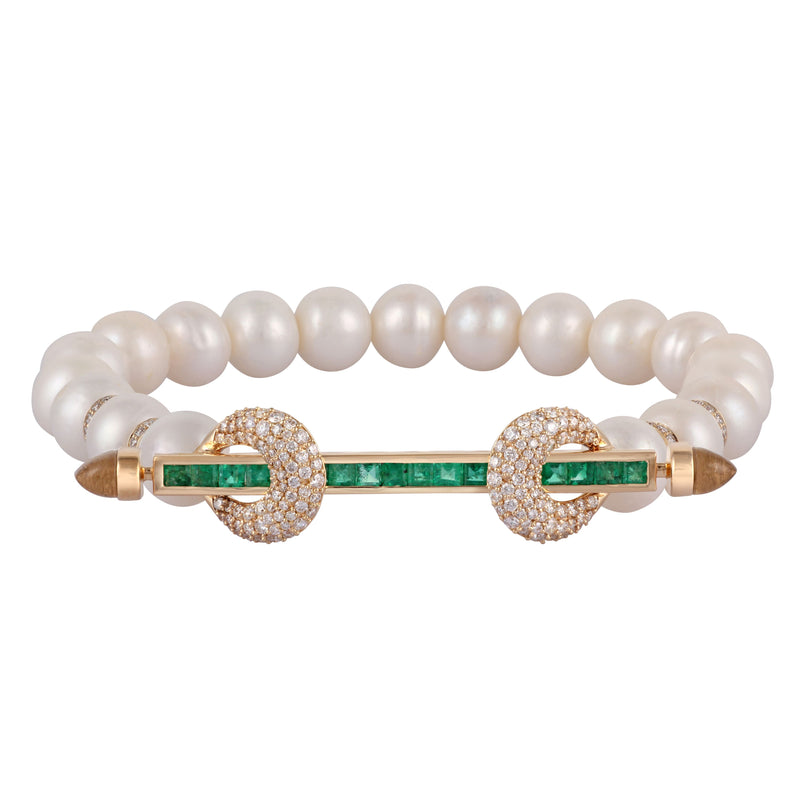 Ananya chakra bracelet with 19 white pearls and 4 diamond rondelle beads. 18k yellow gold bar with square cut emeralds and diamond encrusted loops with cabochon crystals. 