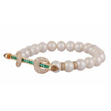 Ananya chakra bracelet with 19 white pearls and 4 diamond rondelle beads. 18k yellow gold bar with square cut emeralds and diamond encrusted loops with cabochon crystals.