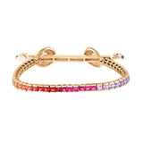 Ananya chakra bracelet with rainbow square cut multi colored sapphires. 18k yellow gold bar with baguette diamonds and diamond encrusted loops with cabochon crystals.