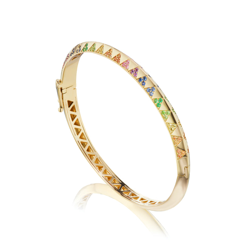 Harwell Godfrey 18k yellow gold bangle with rainbow colored sapphires set in triangular pyramid shapes. 